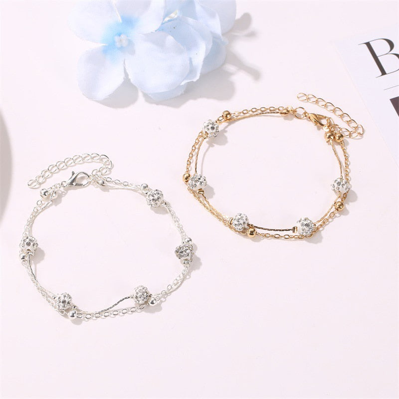 Double bracelet de cheville avec accessoires