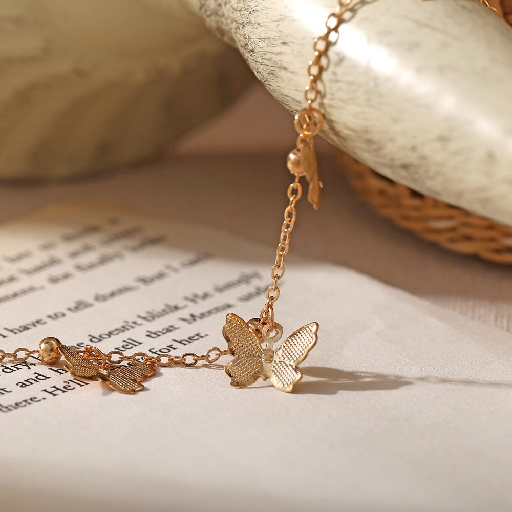 Bracelet de cheville avec pendentifs papillon