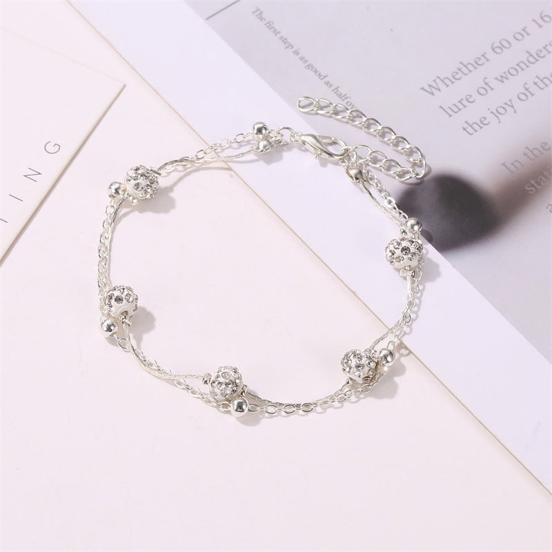 Double bracelet de cheville avec accessoires